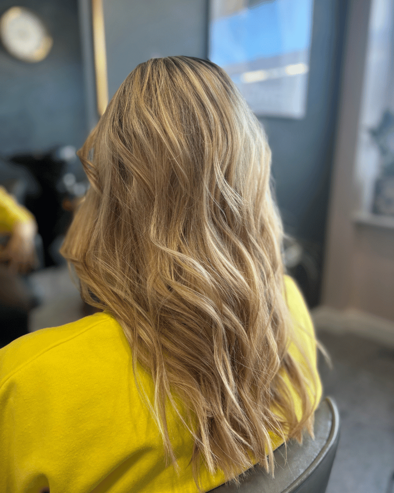 Delikatne fale w odcieniach beżowego blondu po stylizacji w salonie fryzjerskim